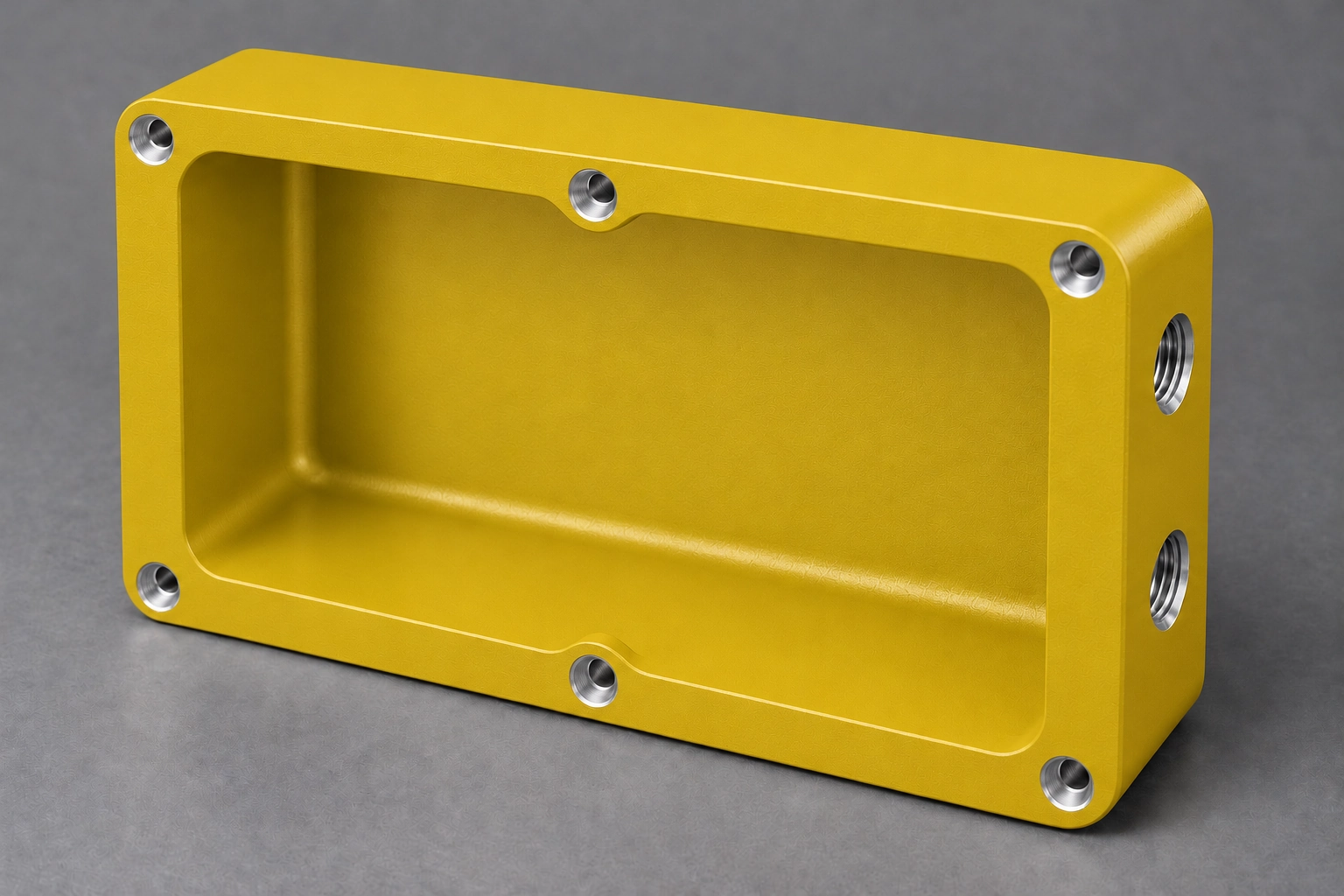 Yellow powder-coated CNC aluminium enclosure finish; bare-metal bores illustrate masking