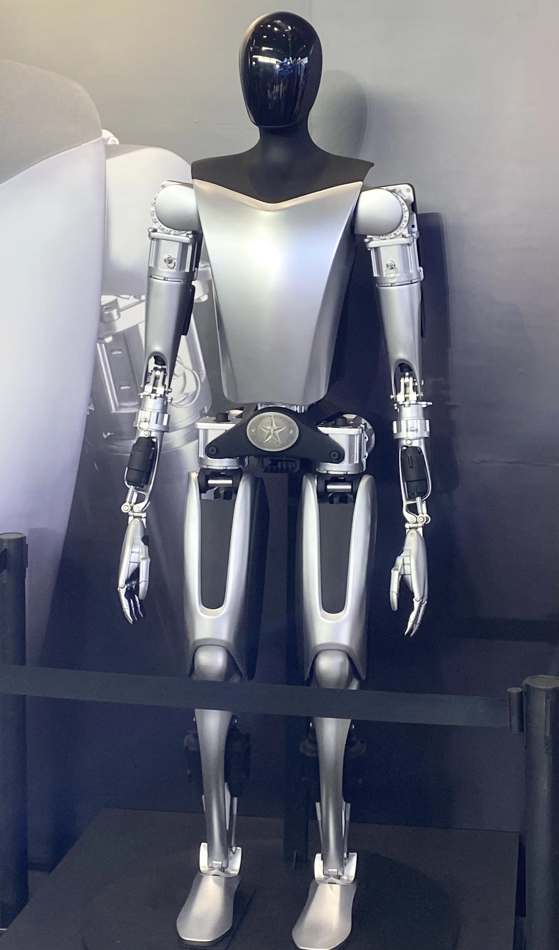 Tesla Optimus — humanoid robot photograph showing the hip and leg structure