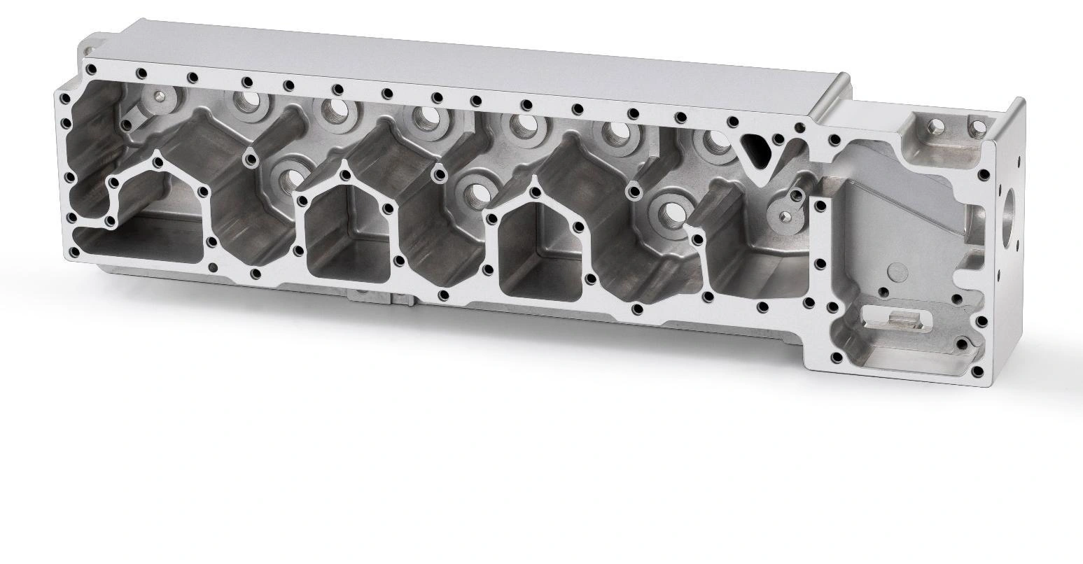 CNC-machined metal block with clearly visible precision bores and milled features